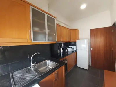 a kitchen with a sink and a white refrigerator at Jose's Place Holiday Apartment in Funchal