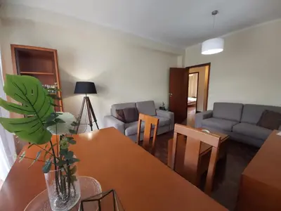 a living room with a table and a couch at Jose's Place Holiday Apartment in Funchal