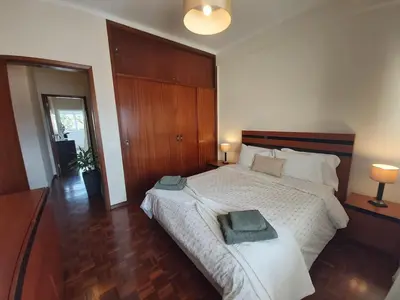 a bedroom with a large bed with two towels on it at Jose's Place Holiday Apartment in Funchal