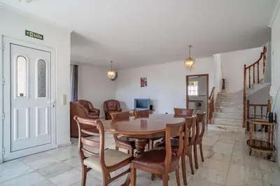 a kitchen with a sink and a brick fireplace at Casa Bom Sucesso in Funchal