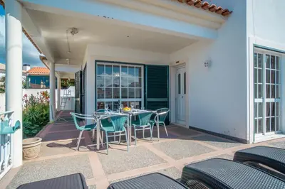 a kitchen with a wooden table and a refrigerator at Casa Bom Sucesso in Funchal
