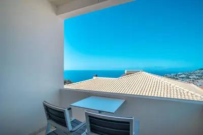 a patio with a table and chairs on a house at Casa Bom Sucesso in Funchal