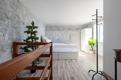 a bedroom with a bed and a stone wall at Casa Morena - Private Tropical Oasis in Campanário