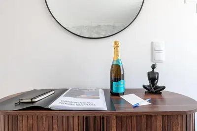 a bottle of champagne on a table with a mirror at Casa Morena - Private Tropical Oasis in Campanário