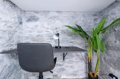 a desk with a chair and a lamp and a plant at Casa Morena - Private Tropical Oasis in Campanário