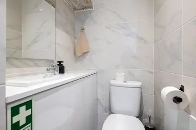 a white bathroom with a toilet and a sink at Casa Morena - Private Tropical Oasis in Campanário