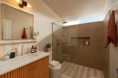 a bathroom with a shower and a sink and a toilet at THE BOAT HOUSE Sea Front and Private Pool in Funchal