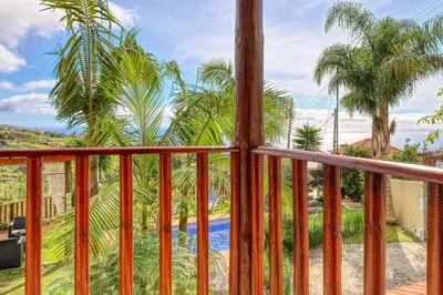 a view from the balcony of a resort with a pool at Ricardo House, a Home in Madeira in Calheta