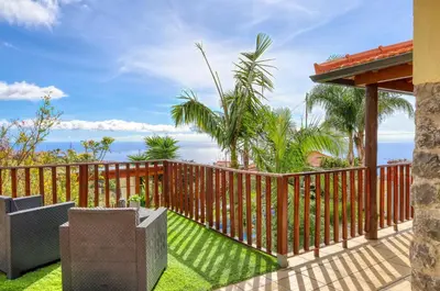 a deck with a fence and a view of the ocean at Ricardo House, a Home in Madeira in Calheta