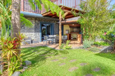 a patio of a house with a table and chairs at Ricardo House, a Home in Madeira in Calheta