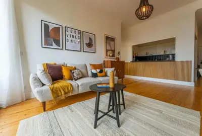 a living room with a couch and a table at Modern City Apartment Funchal in Funchal