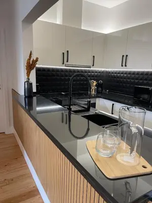 a kitchen with a counter with glasses on it at Modern City Apartment Funchal in Funchal
