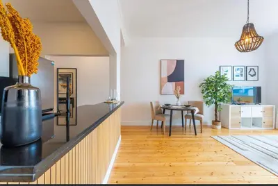 a kitchen with a table and a dining room at Modern City Apartment Funchal in Funchal