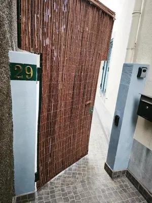 a wooden door with the number on it at Apartamento MONTECORUJEIRA in Funchal
