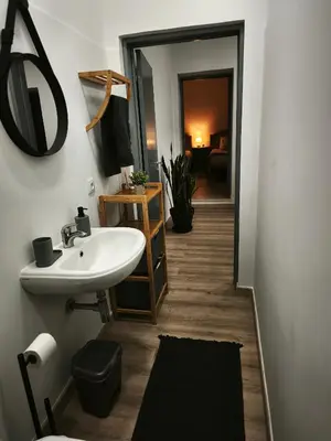 a bathroom with a sink and a mirror at Apartamento MONTECORUJEIRA in Funchal