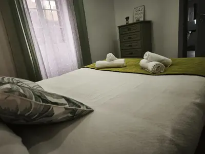 a bedroom with a bed with towels on it at Apartamento MONTECORUJEIRA in Funchal