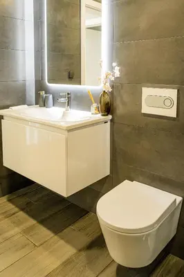 a bathroom with a white toilet and a sink at Casa da Lombada in Ponta do Sol
