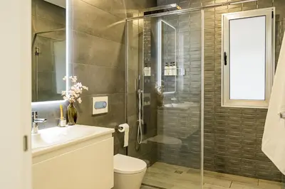 a bathroom with a shower and a toilet and a sink at Casa da Lombada in Ponta do Sol