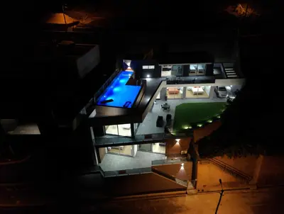 an aerial view of a house with a pool at night at Casa da Lombada in Ponta do Sol