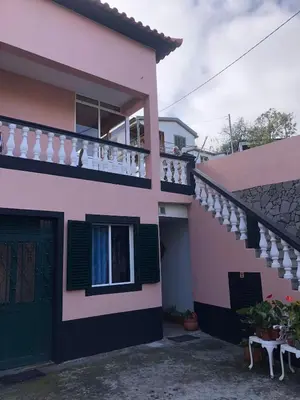 a pink and black house with a balcony at Loft in Calheta Madeira in Calheta