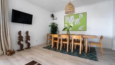 a dining room with a table and chairs on a rug at Amaro Oasis by LovelyStay in Funchal
