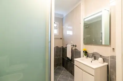 a bathroom with a sink and a mirror at Radiantescapadela in Estreito da Calheta