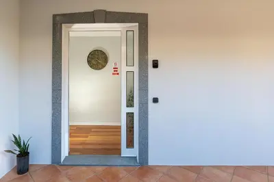 a white door with a mirror on the wall at Radiantescapadela in Estreito da Calheta