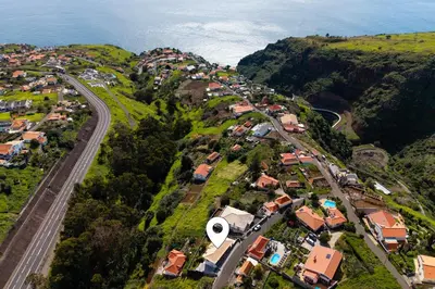 an aerial view of a city with a road and houses at Radiantescapadela in Estreito da Calheta