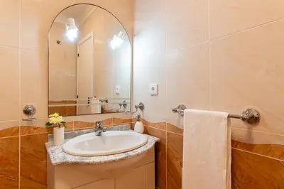 a bathroom with a sink and a mirror at Radiantescapadela in Estreito da Calheta