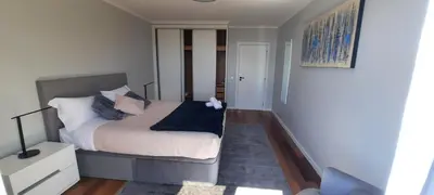 a small bedroom with a bed and a white cabinet at Radiantescapadela in Estreito da Calheta