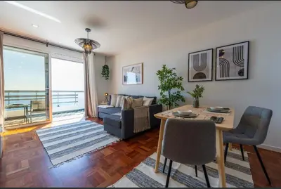 a living room with a couch and a table at Island Time Studio with Sea View in Funchal