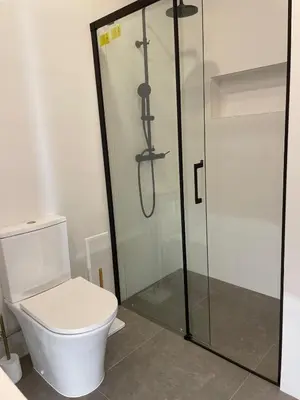 a bathroom with a toilet and a glass shower at Island Time Studio with Sea View in Funchal