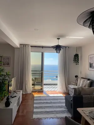 a living room with a view of the ocean at Island Time Studio with Sea View in Funchal