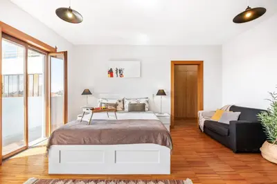 a white bedroom with a bed and a couch at Funchal Heritage Studio in Funchal