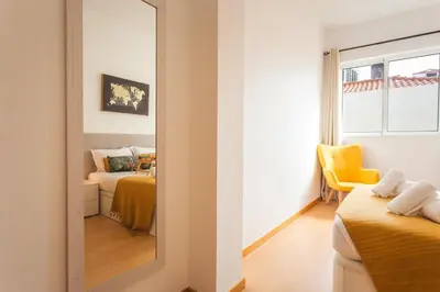 a mirror in a room with two beds at Sao Pedro Central Flat by Atlantic Holiday in Funchal