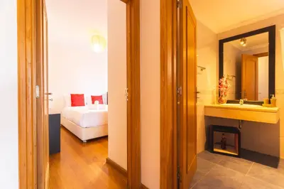 a room with a bedroom with a bed and a bathroom at Sweet Home Reis Magos by Atlantic Holiday in Caniço