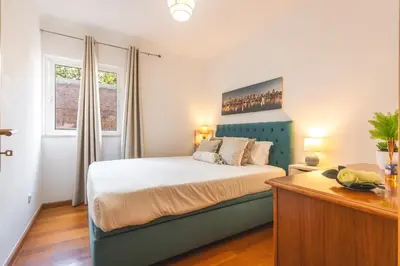 a bedroom with a bed with a blue headboard at Sweet Home Reis Magos by Atlantic Holiday in Caniço