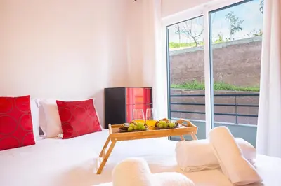 a living room with a table with a bowl of fruit at Sweet Home Reis Magos by Atlantic Holiday in Caniço