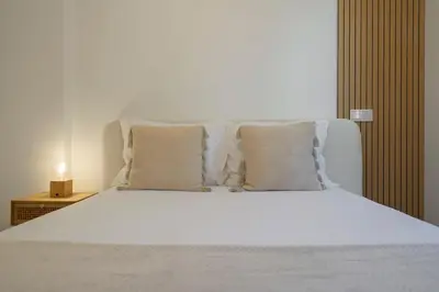 a white bed with white sheets and pillows at Uptown II by An Island Apart in Funchal