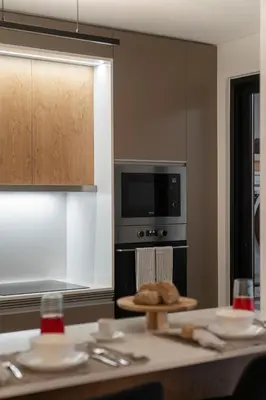 a kitchen with a table with a microwave and a stove at Uptown II by An Island Apart in Funchal