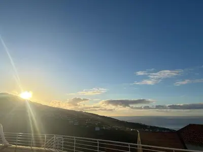a view of the sun setting on a mountain at SunRise Vila in Estreito da Calheta