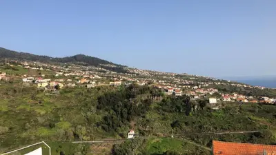 a town on a hill with houses on it at SunRise Vila in Estreito da Calheta