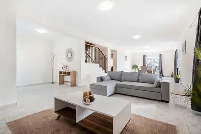 a living room with a couch and a table at SunRise Vila in Estreito da Calheta