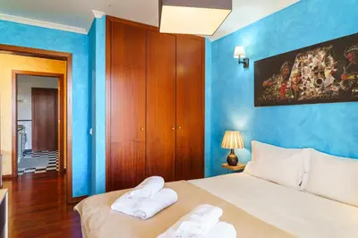 a bedroom with blue walls and a bed with two towels at GuestReady - A homely retreat in São Martinho in Funchal