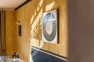 a painting of a cross on the wall of a hallway at GuestReady - A homely retreat in São Martinho in Funchal