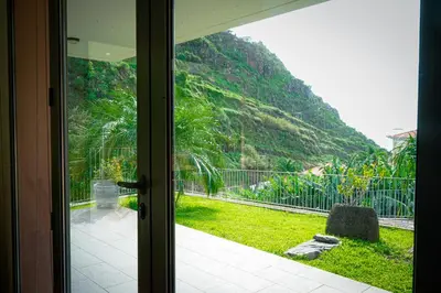 a door to a room with a view of a mountain at Quinta das Rosas in Ribeira Brava