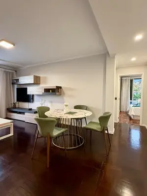 a dining room with a table and green chairs at Funchal Center Inn in Funchal