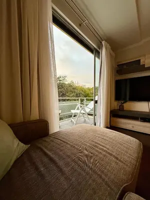 a bedroom with a bed and a large window at Funchal Center Inn in Funchal