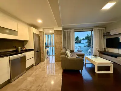 a kitchen and living room with a couch and a table at Funchal Center Inn in Funchal
