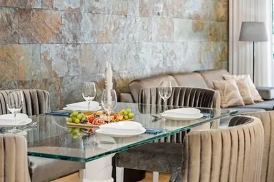 a dining room with a table with a mirror and chairs at White House Premium in Funchal